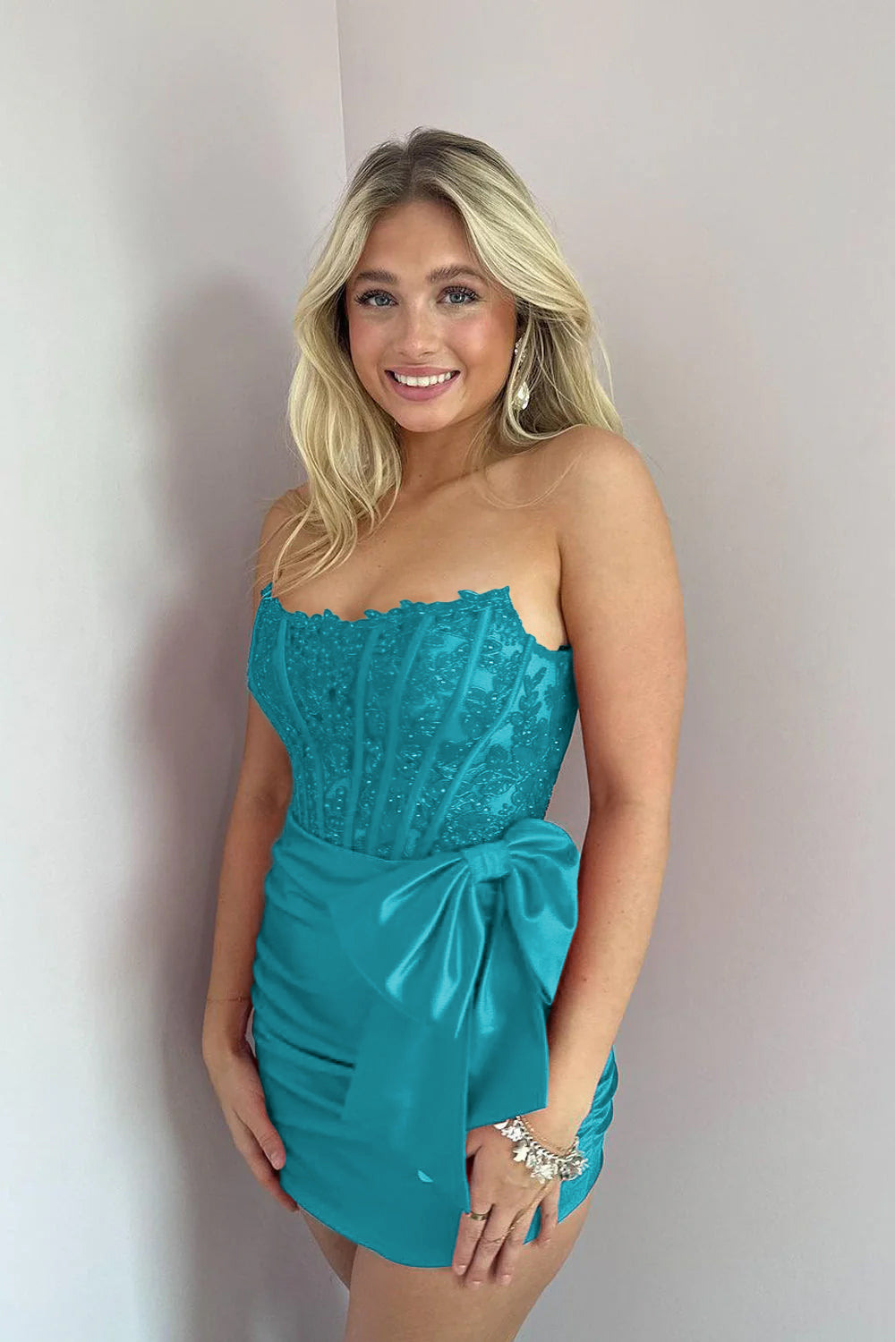 KissDress Strapless Appliques Ruched Homecoming Dress with Bow | This dress is designed in a chic sheath silhouette that hugs your curves beautifully while offering a comfortable fit.