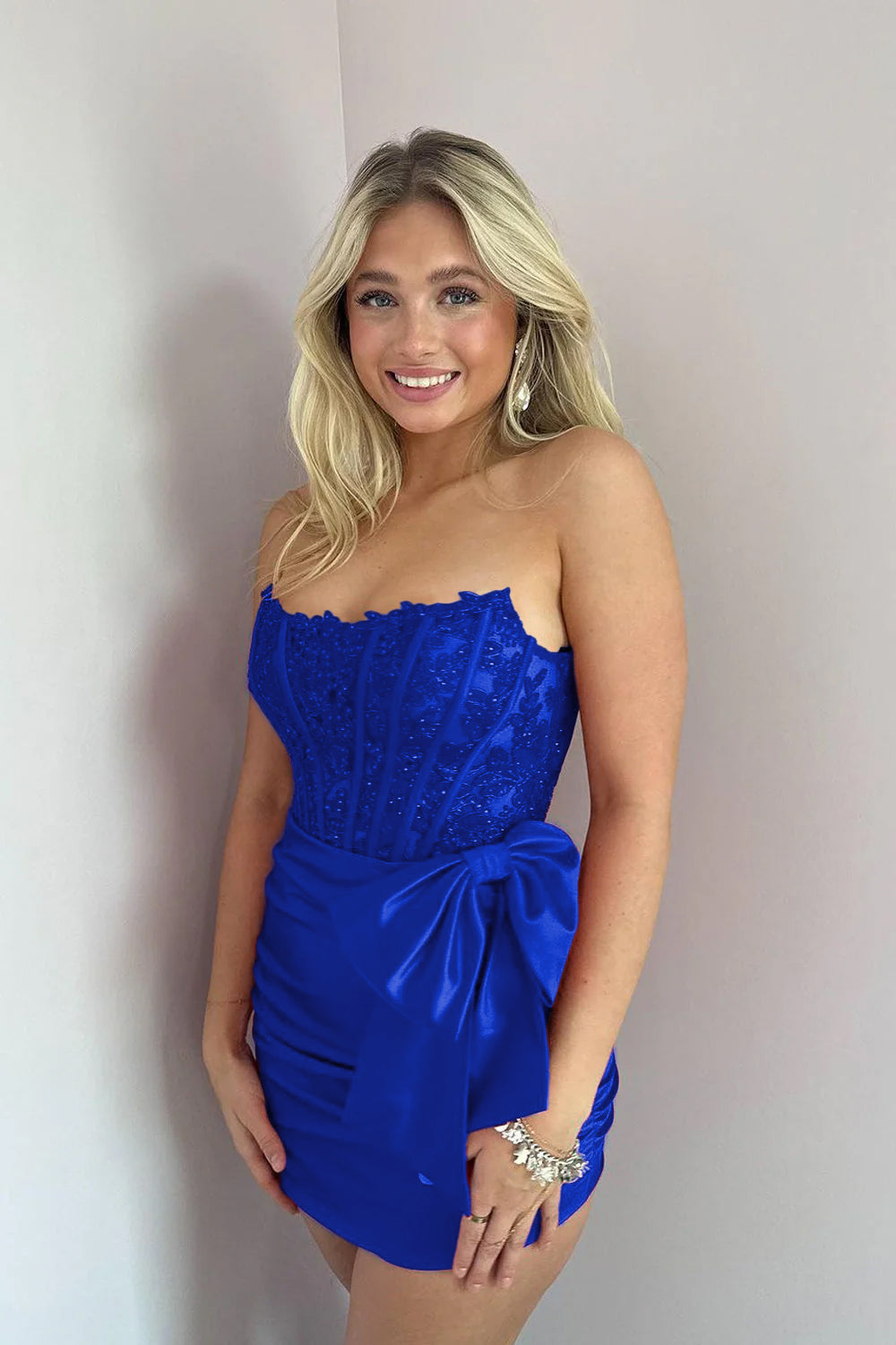 KissDress Strapless Appliques Ruched Homecoming Dress with Bow | This dress is designed in a chic sheath silhouette that hugs your curves beautifully while offering a comfortable fit.